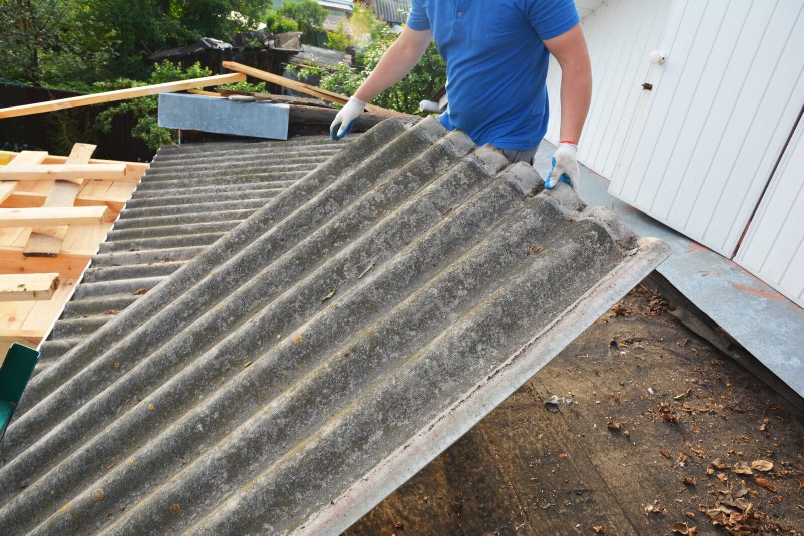 A man performing asbestos abatement on a roof.