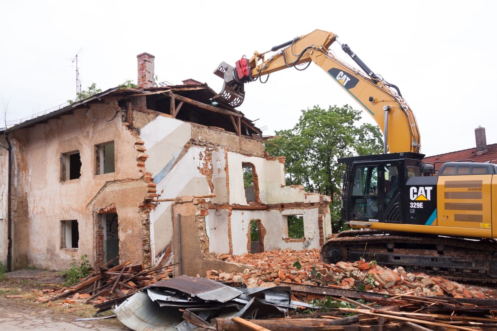 Demolition of a home with an excavator.
